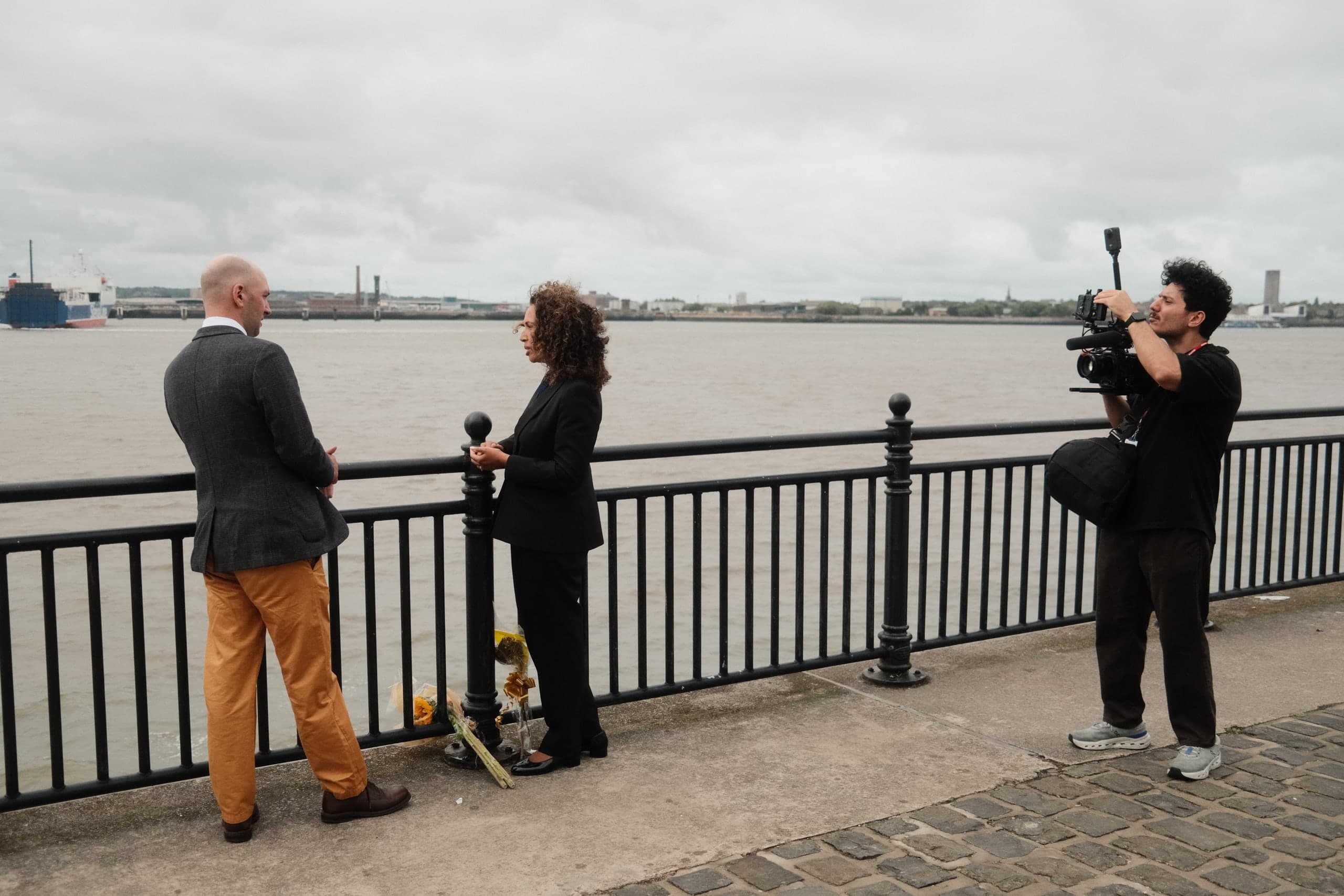 Filming two people in conversation by the river